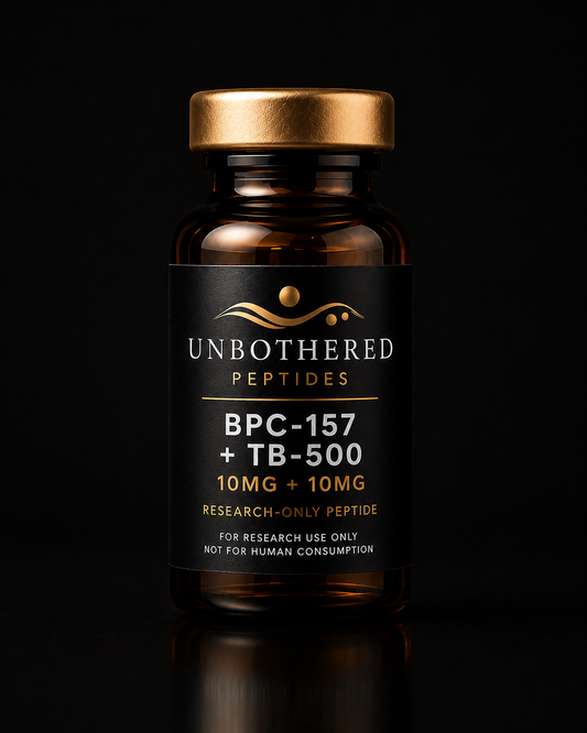 Unbothered Peptides BPC-157 + TB-500 10mg + 10mg research peptide in an amber glass vial with a matte black label, gold cap, and black luxury studio background.