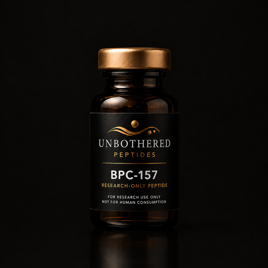 Unbothered Peptides BPC-157 10mg research peptide in an amber glass vial with a matte black label, gold cap, and black luxury studio background.