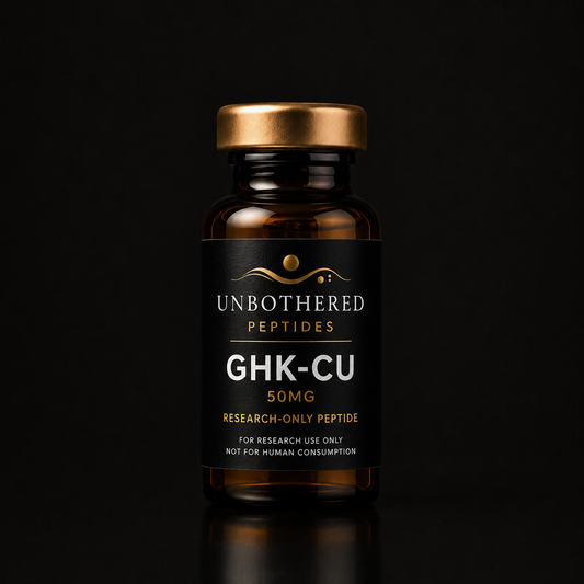 Unbothered Peptides GHK-CU 10mg research peptide in an amber glass vial with a matte black label, gold cap, and black luxury studio background.