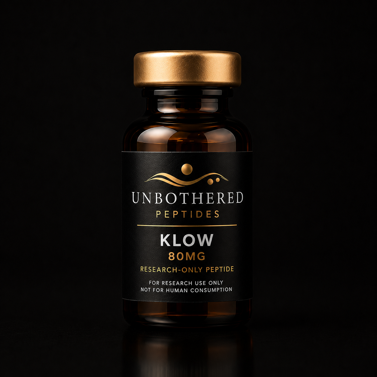 Unbothered Peptides KLOW 80mg research peptide in an amber glass vial with a matte black label, gold cap, and black luxury studio background.