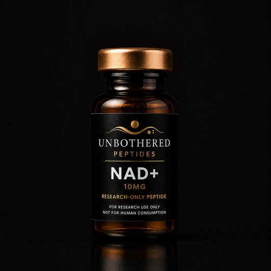 Unbothered Peptides NAD+ 500mg research peptide in an amber glass vial with a matte black label, gold cap, and black luxury studio background.