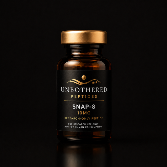 Unbothered Peptides SNAP-8 10mg research peptide in an amber glass vial with a matte black label, gold cap, and black luxury studio background.